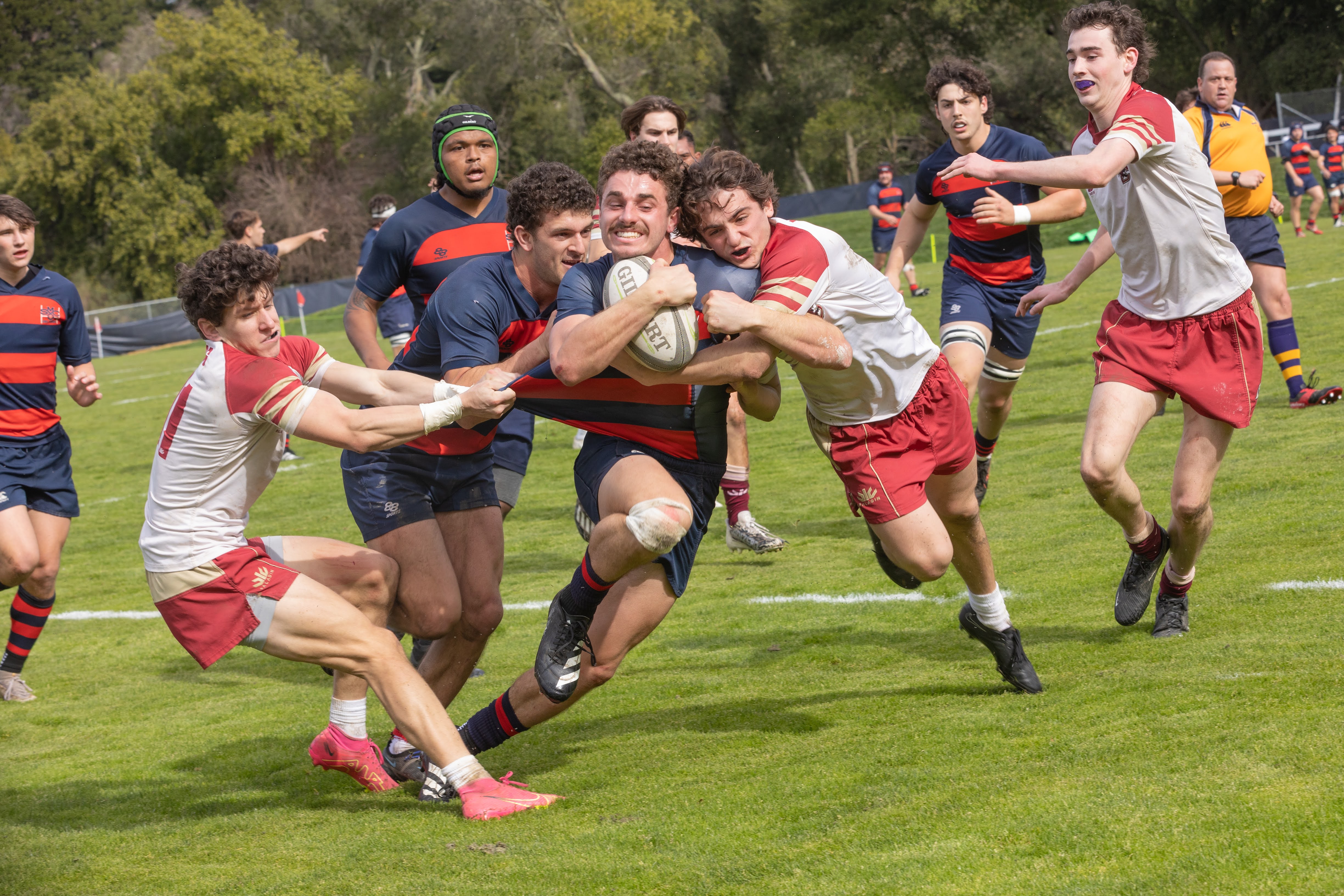 Mario Storti ’26 is pushed into the try zone by Erich Storti MA ’24. / Photo by Rebecca Harper